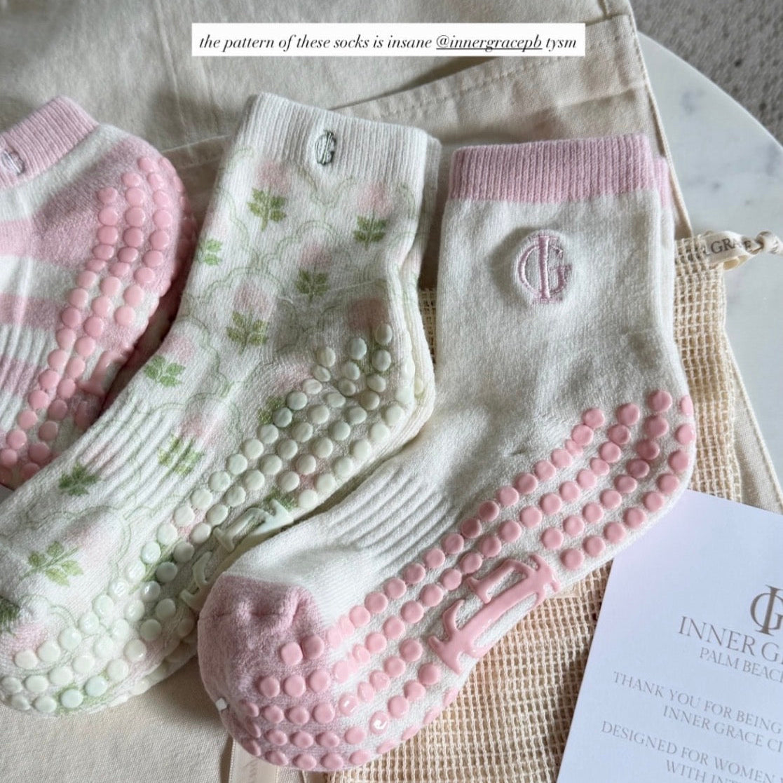 Set of baby socks with textured sole on a marble surface