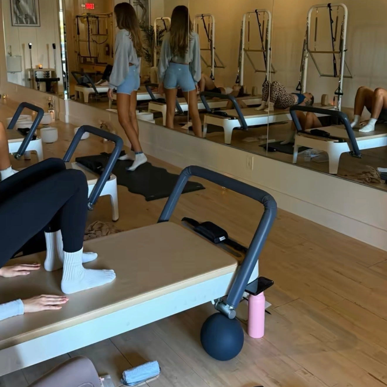 Gym interior with reformers and a person exercising, text '2. Slow Movement' displayed.